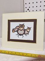 Full view of matted Robert Kakegamic owl print with measuring tape