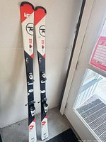 Full view of both Rossignol Experience skis standing upright