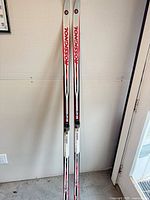 Full view of both Rossignol skis standing upright