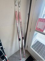 Full view of both Rossignol X-Tour skis leaning against wall