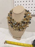 Front view of Aldo beaded collar necklace on display bust