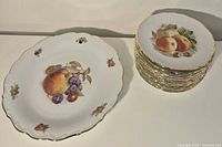 Platter and stacked plates showing design and gold trim