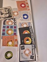 Overview of twelve 45 rpm records with various company sleeves and labels