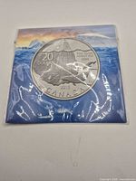 Front view of encapsulated 2013 $20 Iceberg silver coin in presentation sleeve