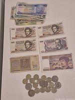 European and other paper currency with several coins displayed