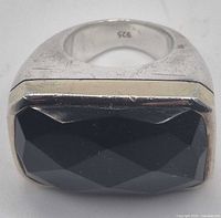 Top view showing faceted black stone set in rectangular sterling bezel and 925 mark inside band