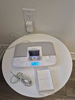 Memorex dock with iPod connected, cable and time display visible