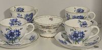 Group view of all cups, saucers and sugar dish