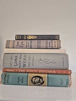 Stack of all five books showing spines and titles