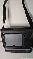 Front view of gray and black Titan cooler bag with shoulder strap and exterior compartment