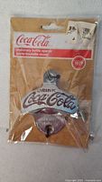 Front view of packaged Coca-Cola bottle opener