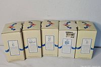 Five sealed Disney Pooh & Friends figurine boxes numbers 5-9 lined up