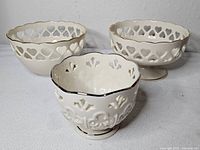 Three Lenox ivory openwork bowls front and back