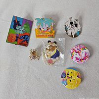 Full group of seven pins and buttons on white background