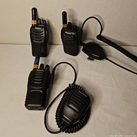 Overall lot showing three Retevis radios and Baofeng mic
