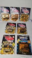 Eight sealed carded die-cast cars laid out showing front packaging