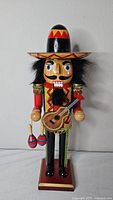Front view of Mexican musician nutcracker showing sombrero, guitar, maracas and costume