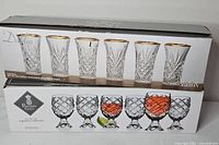 Front of two boxed glass sets showing product images and labels