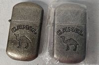 Front view of both Camel lighters showing embossed logos