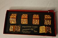 Set of six knife caddies in original box