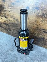 Front view of Black Jack 12-ton hydraulic bottle jack showing chrome piston extended