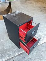 Cabinet front left view with both red drawers open