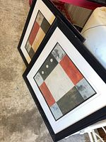 Both framed prints leaning together