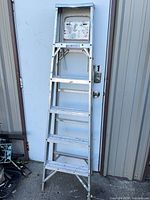 Front view of aluminum A-frame stepladder showing five steps and tool tray