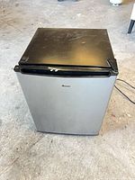 Front view of closed mini refrigerator showing metallic gray finish