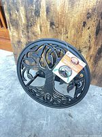Front view of decorative tree motif hose reel