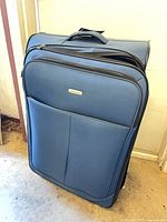 Large blue Samsonite Advance XLT suitcase front view standing upright
