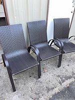 Front view of three matching resin wicker chairs