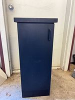 Front view of black storage cabinet closed