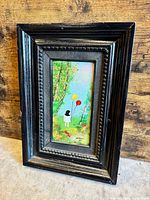 Front view of framed Louis Cardin enamel painting