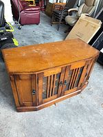 Three-quarter top view of wooden media console cabinet showing overall form and finish