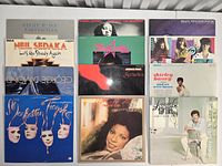 Front covers of 12 vinyl LPs laid out