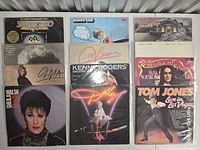 Front covers of all 12 records arranged in three columns, titles partly visible