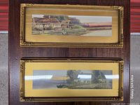 Two gold gilded panoramic frames displayed front view