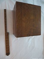 closed oak card holder box beside ruler