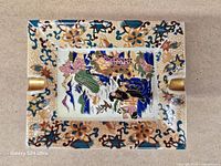 Top view showing full ashtray design with geisha scene and gilded rests