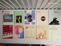 Front covers of 10 sheet-music books laid out on table