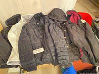 All five jackets and coats laid out showing fronts, colors and styles