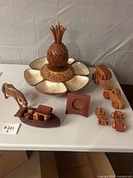 Group shot of serving tray with pineapple, donkey figurine, boat, cars, frame