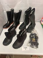 Overall lot showing three pairs of boots and sealed gloves