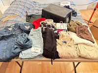 Table with nine women’s clothing items folded