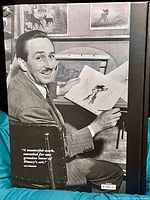 Back cover photograph of Walt Disney holding Bambi animation drawing