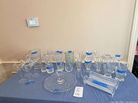 overview of assorted clear glass serveware and stemware on table
