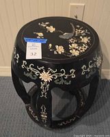 Full view of black lacquered garden seat