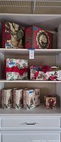 Shelf view showing all decorative Christmas boxes and tissue cover