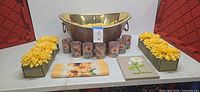 Overall lot showing copper tub, six votives, two sunflower planter boxes, textile, and plaque